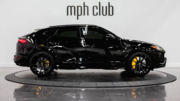 Black on yellow Lamborghini Urus rental side view - mph club