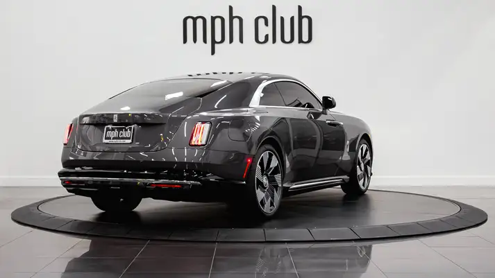 Dark grey Rolls Royce Spectre rental rear view - mph club