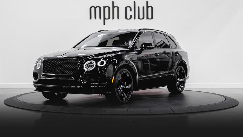 Black on red Bentley Bentayga rental profile view - mph club