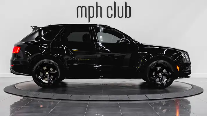 Black on red Bentley Bentayga rental side view - mph club