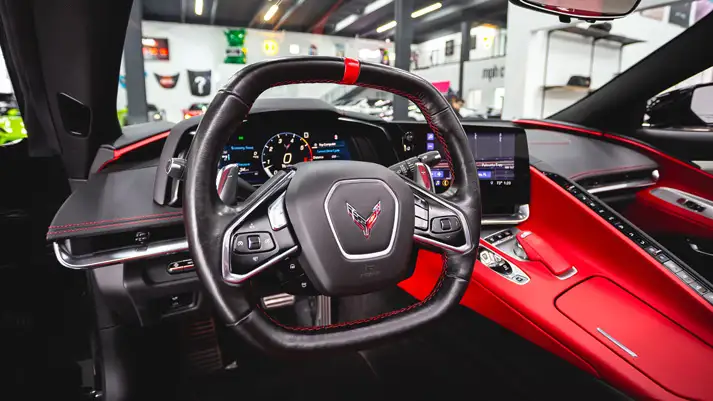 Black on red Corvette C8 rental dashboard view - mph club