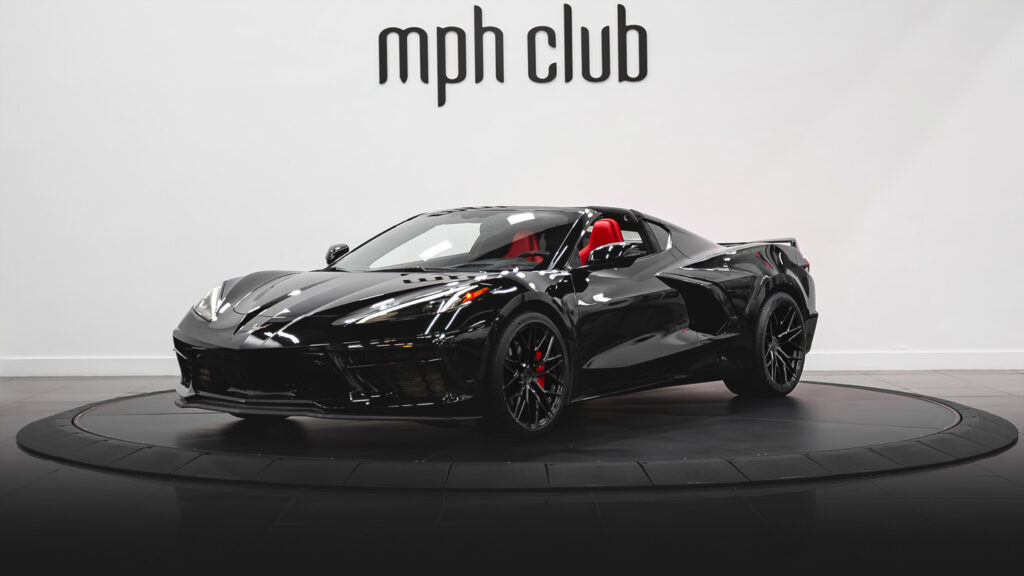 Black on red Corvette C8 rental profile view - mph club