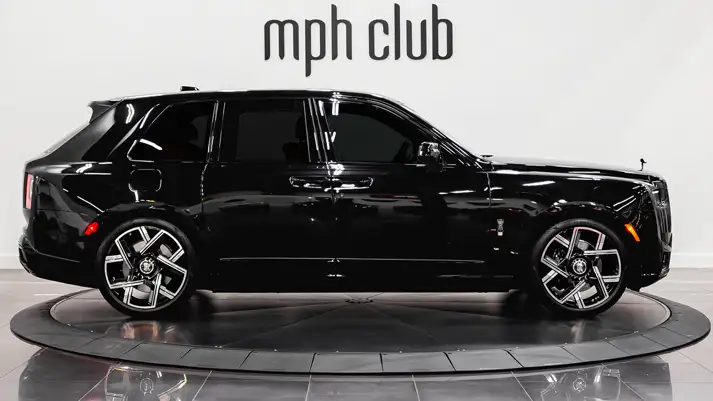 Black on orange interior Rolls Royce Cullinan Black Badge rental side view - mph club