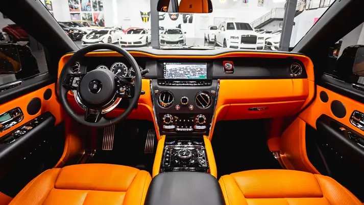 Black on orange Rolls Royce Cullinan rental dashboard view - mph club