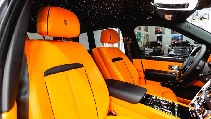 Black on orange Rolls Royce Cullinan rental interior view - mph club