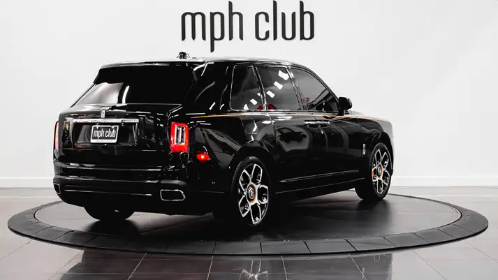 Black on orange Rolls Royce Cullinan rental rear view - mph club