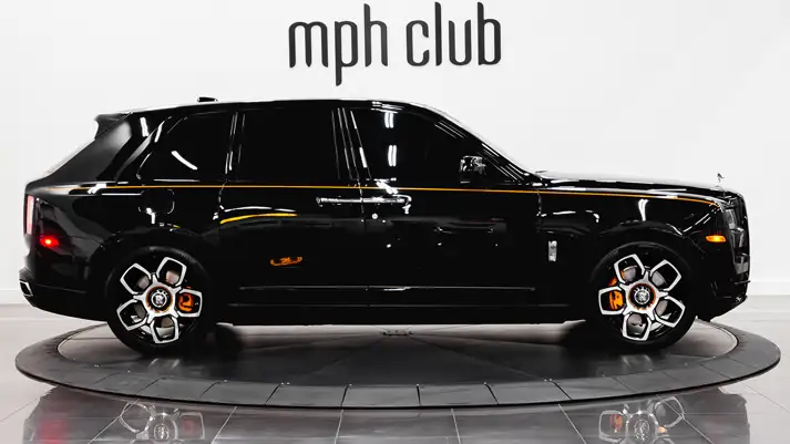 Black on orange Rolls Royce Cullinan rental side view - mph club