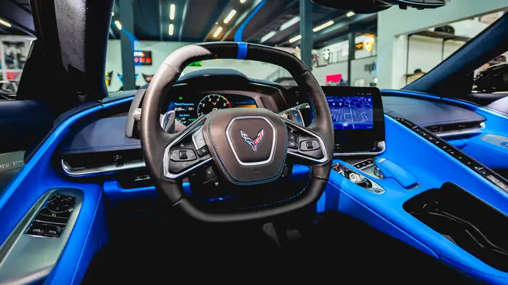 Black on blue Chevrolet Corvette C8 rental dashboard view - mph club