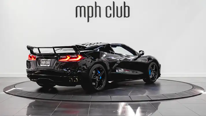 Black on blue Chevrolet Corvette C8 rental rear view - mph club