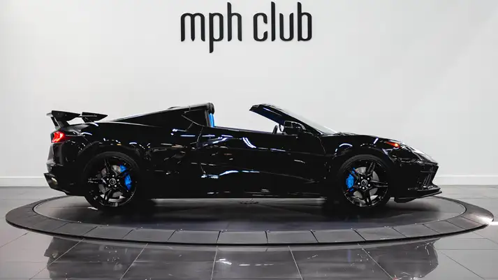 Black on blue Chevrolet Corvette C8 rental side view - mph club
