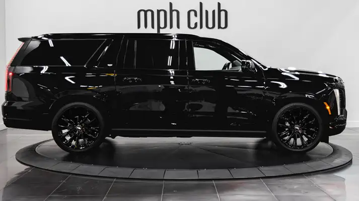 Black on black Cadillac Escalade ESV rental side view - mph club