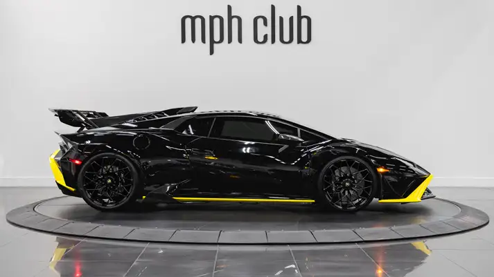 Black Lamborghini Huracan STO rental side view - mph club