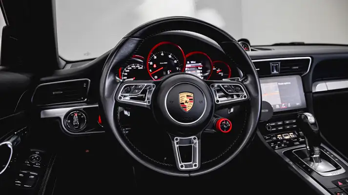 Red Porsche 911 Carrera Cabriolet rental dashboard view - mph club