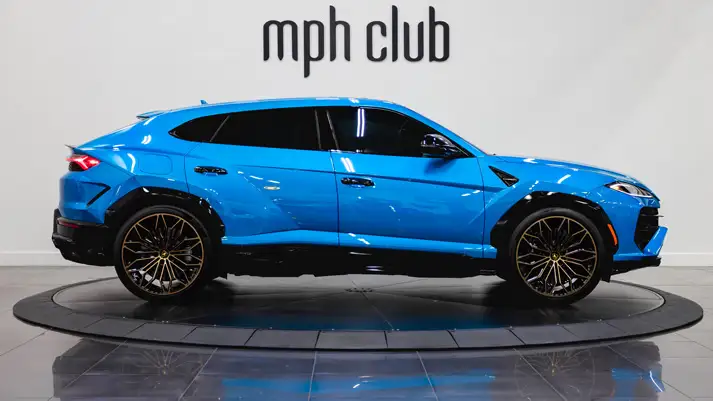 Blue Lamborghini Urus SE rental side view - mph club