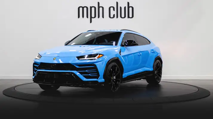 Light blue on white Lamborghini Urus rental profile view rszd - mph club