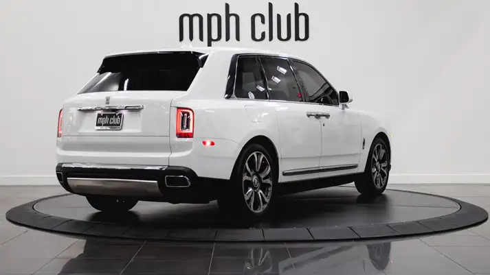 White on light blue Rolls Royce Cullinan rental rear view - mph club