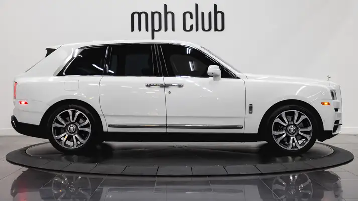White on light blue Rolls Royce Cullinan rental side view - mph club